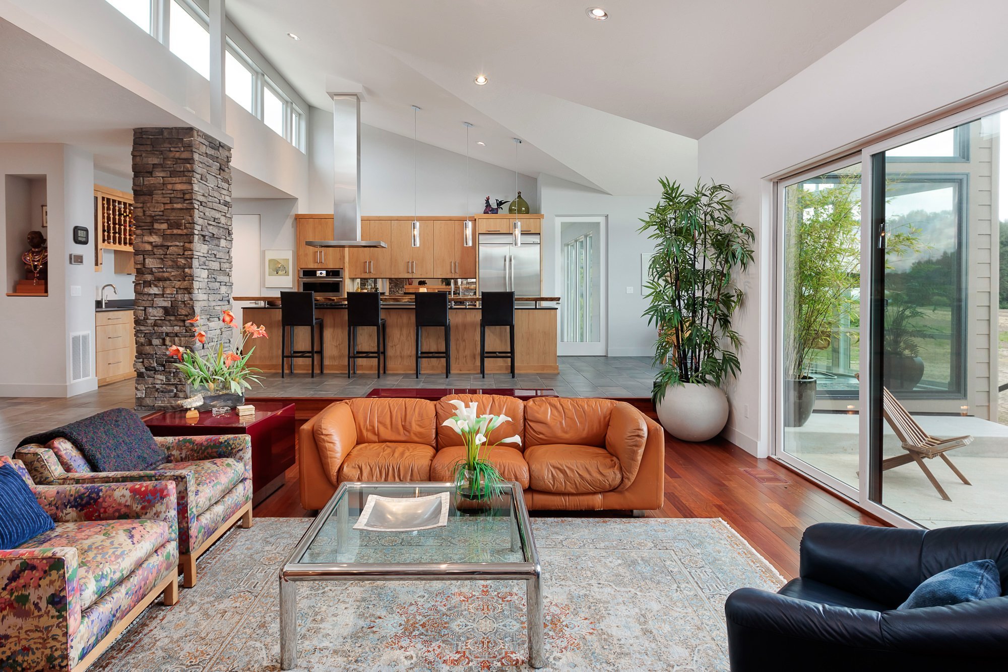Open-concept living room and kitchen with designed lighting